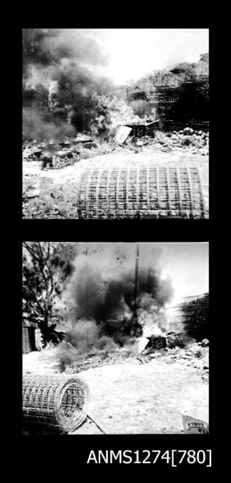 Two black-and-white negatives, joined together, of smoke near wire cages and a large roll of wire, on Packe Island