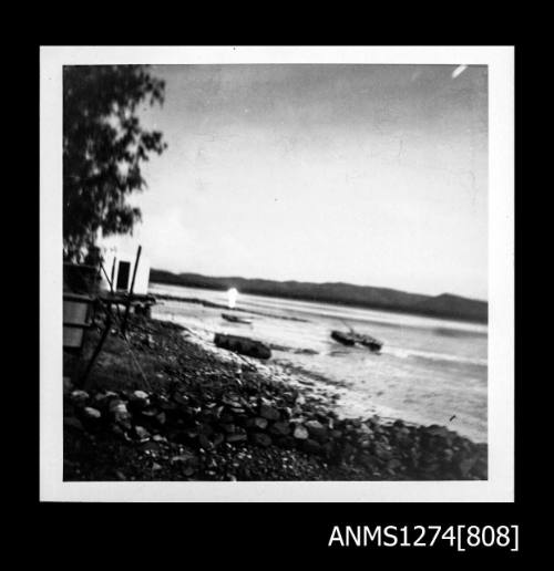 The shoreline on Packe Island, and possibly a pearl raft in the water