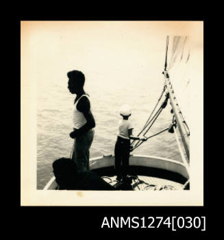 A young boy and a Papua New Guinean [?] male on a boat, on Packe Island