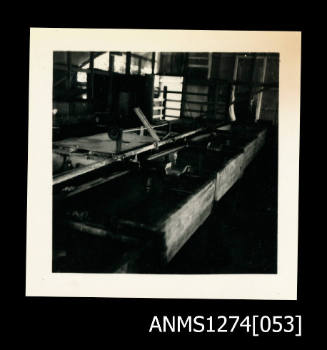 Photograph of large boxes/basins within a shed or house on Packe Island, used to hold pearl shells