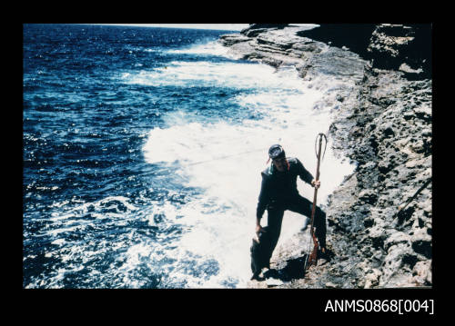 Bob Lynch at Jervis Bay holding home made spear gun and wearing diving gear