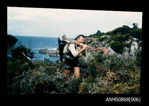 Bob Lynch at Towra Point carrying home made spear gun and fish