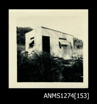 The outside of a tin shed (as photographed in ANMS1274[147]-[149])