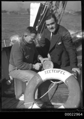 Cook, Hohn Winter, on board SEETEUFEL with an unidentified man