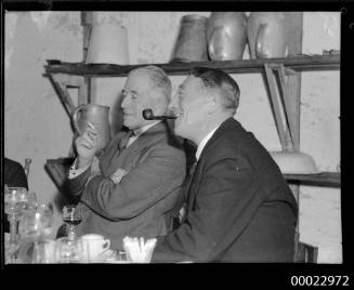 Count Felix Graf von Luckner smoking a pipe next to an unidentified man