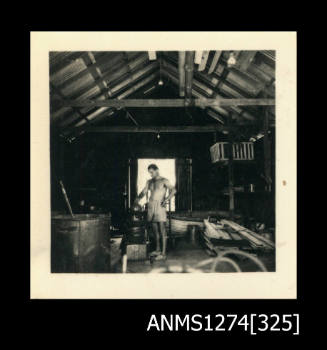 The inside of a shed, with Denis George standing in front of the doorway, on Thursday Island