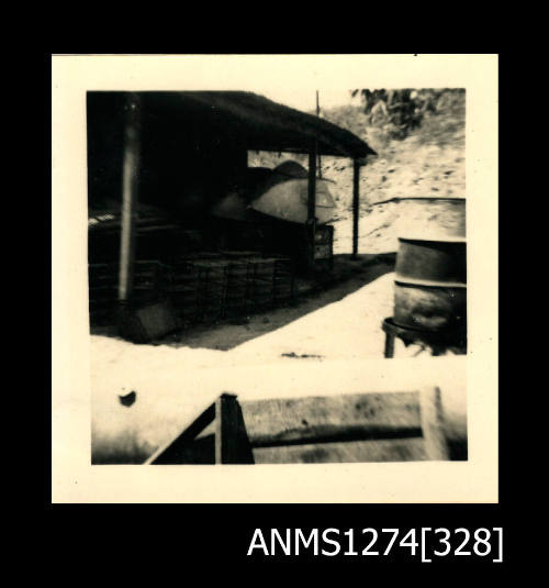 The outside of a shed, with pearl cages and several metal drums, on Thursday Island