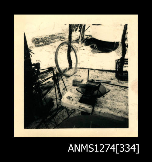 A table under a shade cloth, with various pieces of equipment, on Thursday Island