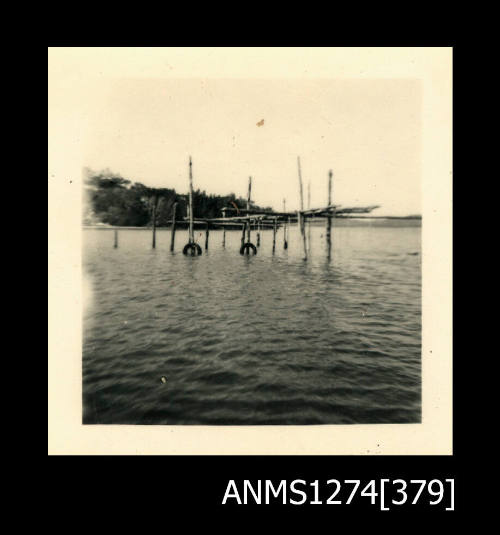 A wooden pearl structure, composed from wooden poles over water, on Packe Island