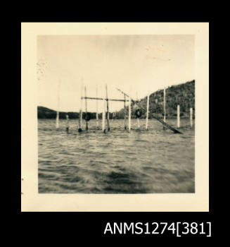 A wooden pearl structure, composed from wooden poles over water, on Packe Island