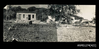 A pebble beach, with sheds, on Packe Island