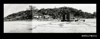 A beach, with sheds, equiptment, etc, on Packe Island