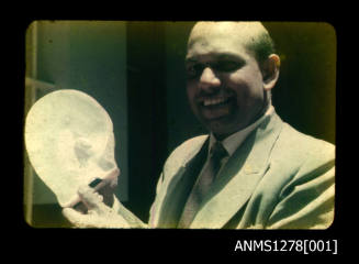 35mm colour transparency of a man holding a pearl shell