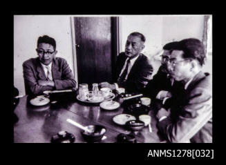 Four Japanese men sitting around a table