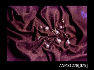 35mm colour transparency of pearl shell jewellery, displayed on a cloth