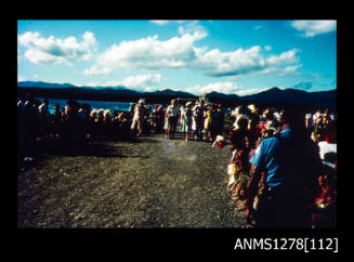 35mm colour transparency of numerous people welcoming Queen Elizabeth II