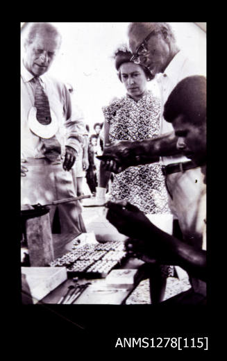Queen Elizabeth II, Prince Philip and Denis George, watching a pearl demonstration