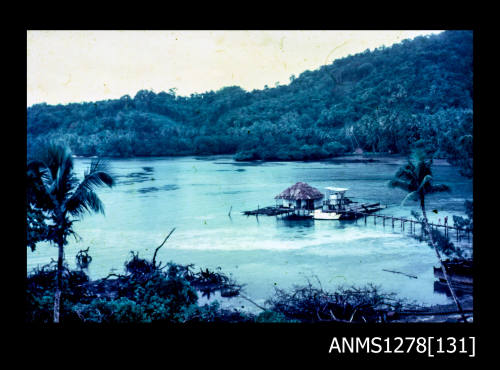 35mm colour transparency of a building over the water, with a wooden jetty