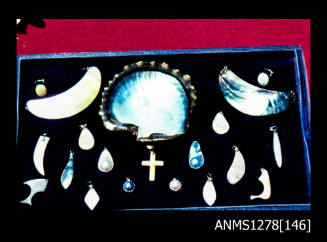 35mm colour transparency of a display box filled with shell and pearl jewellery, and a pearl shell with a blister pearl