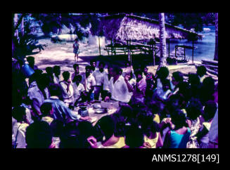 35mm colour transparency of numerous Papua New Guinean people sitting on a beach