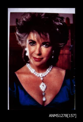 35mm colour transparency of Elizabeth Taylor wearing a pearl necklace
