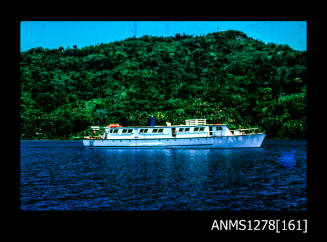 35mm colour transparency of a boat in the water, in front of land