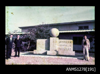 35mm colour transparency of a pearl sculpture, with Japanese men and Denis George standing on both sides