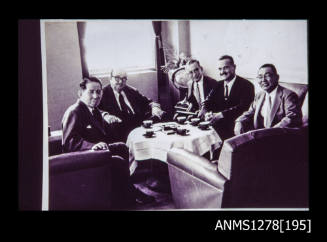 Five men sitting around a table