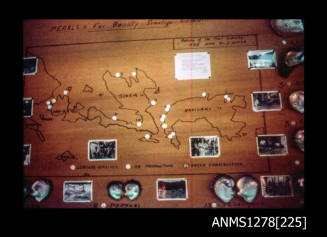 35mm colour transparency of a map with photographs and pearl shells