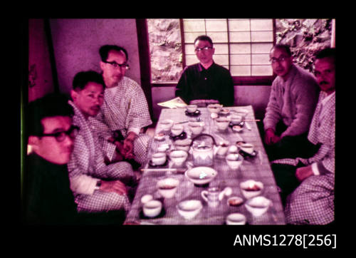 35mm colour transparency of six men, including Denis George, sitting around a dinner table, wearing kimonos