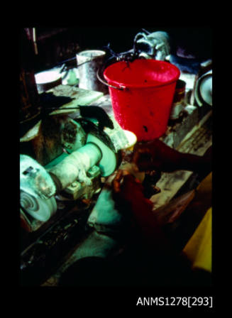 35mm colour transparency of a red bucket and pearl making equipment, possibly a grinder