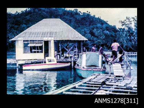 35mm colour transparency of a shed, boat and raft on the water