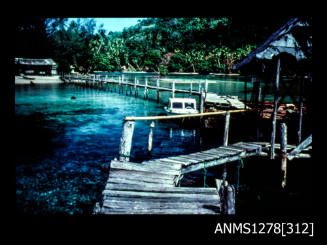 35mm colour transparency of a shed and wharf over the water