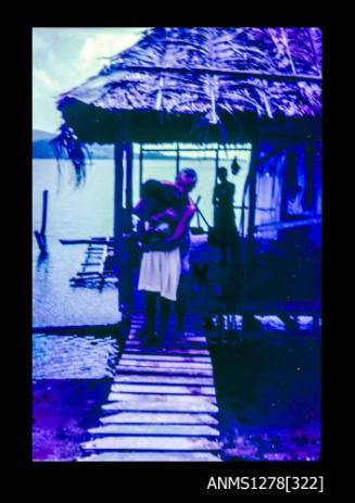 35mm colour transparency of two people hugging in front of a shed