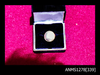 35mm colour transparency of a pearl earring in a puple velvet jewellery display case