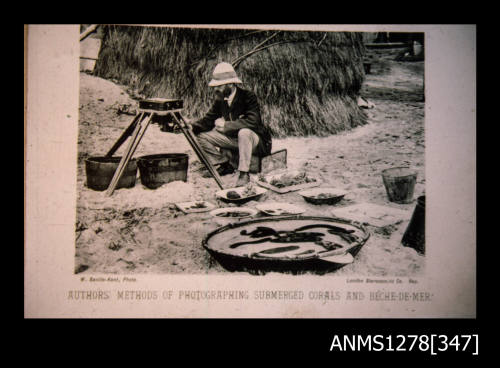 An old photograph of a man with a camera on a stand