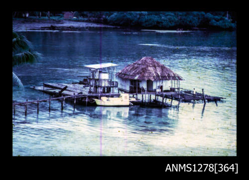 35mm colour transparency of a pearl shelter and raft over the water