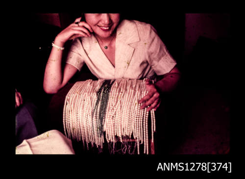 35mm colour transparency of a Japanese woman with numerous strings of pearls