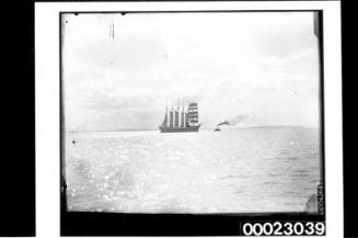 Six-masted barquentine E R STERLING with a tug at sea