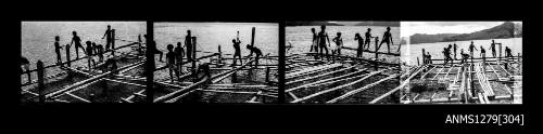 Strip of four black-and-white negatives of numerous men building a wooden pearl production raft