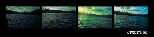 Strip of four colour negatives from Pearl Island, the first two of land and water, the third of buoys in the water attached to rope, and the fourth of a man holding onto rope in the water