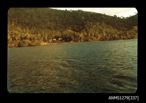 Colour photograph of land and water, taken from a boat, on Pearl Island