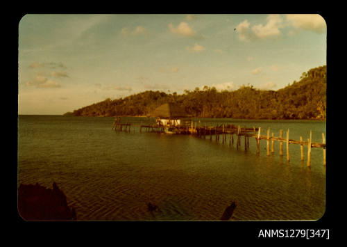 Colour photograph, possibly of a pearl production raft, consisiting of a shed and wooden wharf, taken on Pearl Island