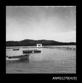 A pearl production raft, with a boat in the forefront