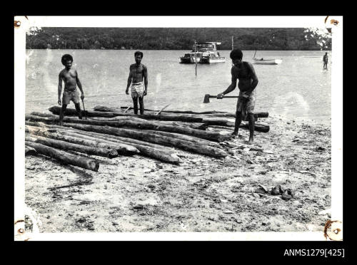 Photograph of several Papua New Guinean men tying rope onto a pearl production raft