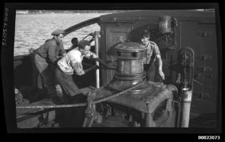 Crew members operating a winch on board EVERETT G GRIGGS