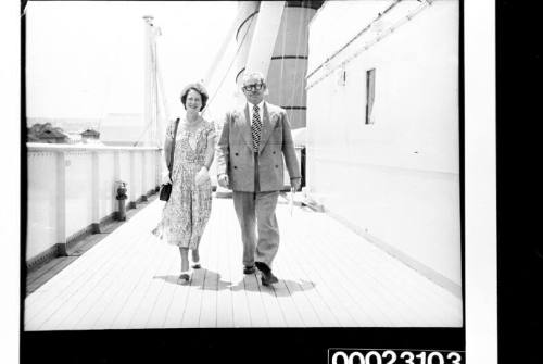 Two passengers walking on the deck of RMS CARONIA