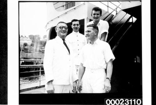 Four unidentified men posing on board RMS CARONIA