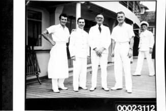 Four unidentified men posing on board RMS CARONIA