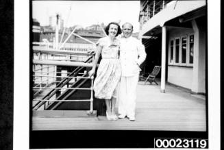 Unidentified woman and a crew member posing on board RMS CARONIA